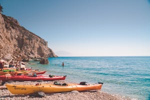 Vibrant kayaks on a stunning Samos beach, perfect for adventure seekers.